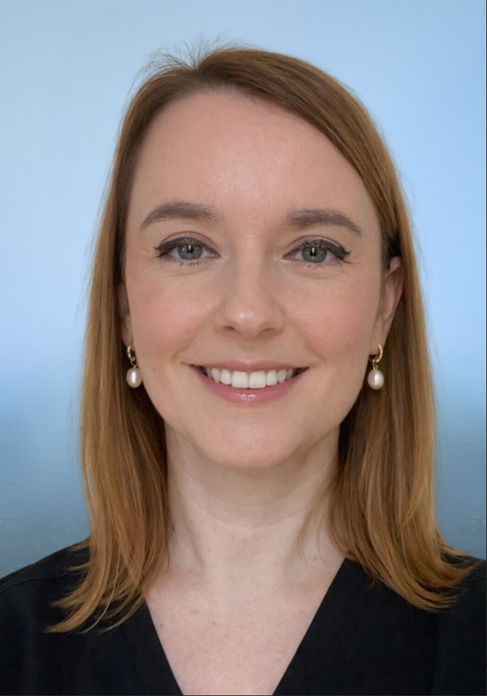 Smiling Woman with White Teeth and Red Curly Hair